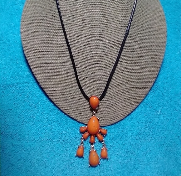 Jewelry - Goldtone orange abstract dangle necklace black cord